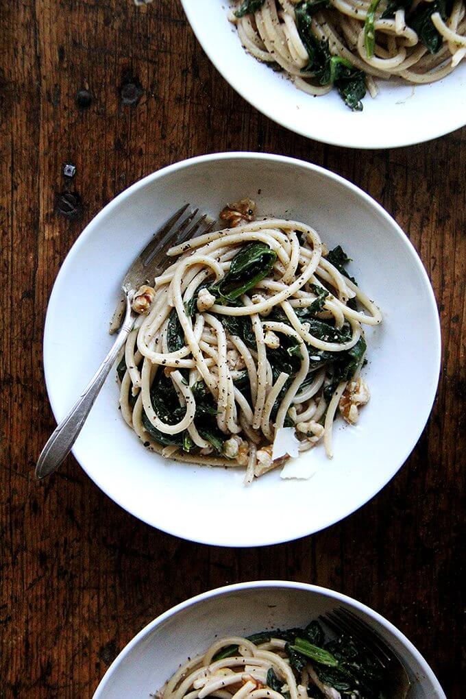 This pasta with spinach, walnuts, and lemon includes fresh greens tossed with a garlicky, white wine sauce made slightly creamy with crème fraîche. Yum. // alexandracooks.com This pasta with spinach, walnuts, and lemon includes fresh greens tossed with a garlicky, white wine sauce made slightly creamy with crème fraîche. Yum. // alexandracooks.com