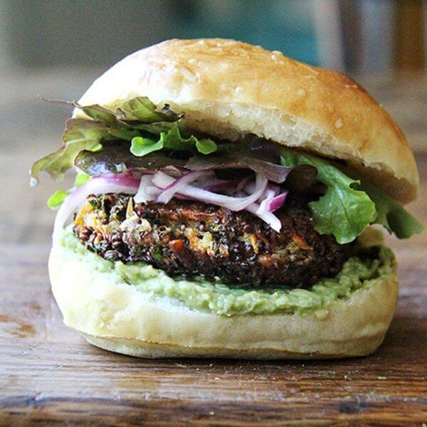 A mushroom-quinoa veggie burger on a board.
