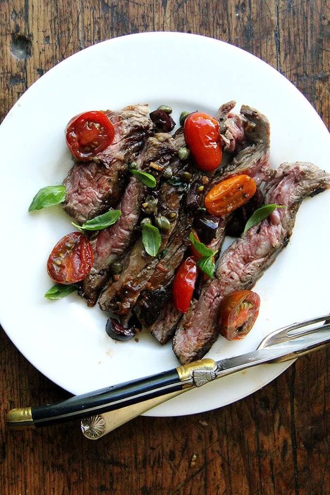 In this skirt steak nicoise, while the skirt steak rests, you’ll make a simple sauce Niçoise. After halving cherry tomatoes, coarsely chopping olives, and tossing the two with capers, you’ll briefly sauté the mix with olive oil and garlic. After just a few minutes, the tomatoes will begin to break down, releasing juices and sweetening as they soften. A squeeze of fresh lemon juice at the end offers a welcomed hit of acidity. // alexandracooks.com In this skirt steak nicoise, while the skirt steak rests, you’ll make a simple sauce Niçoise. After halving cherry tomatoes, coarsely chopping olives, and tossing the two with capers, you’ll briefly sauté the mix with olive oil and garlic. After just a few minutes, the tomatoes will begin to break down, releasing juices and sweetening as they soften. A squeeze of fresh lemon juice at the end offers a welcomed hit of acidity. // alexandracooks.com