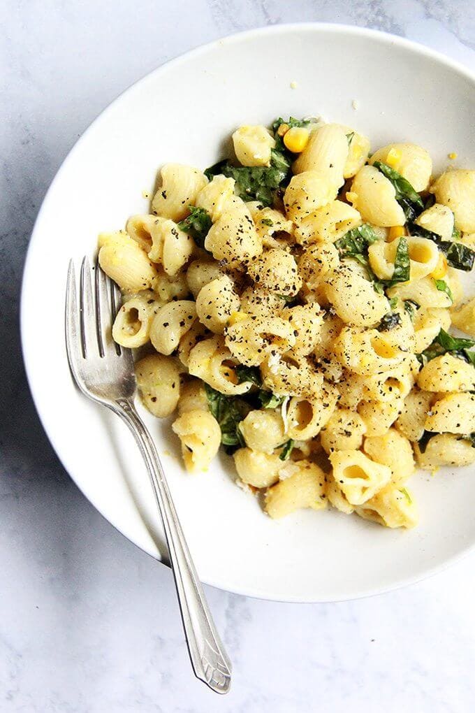 This creamy corn pasta has since become one of my favorite summer meals, and it's simple, too: strip two ears of corn, sauté the kernels in butter with scallions, purée the mixture into a sauce, then toss it with pasta, fresh lemon, basil, parmesan, and chili flakes. If you make one thing this weekend let it be this pasta. // alexandracooks.com A bowl of creamy corn pasta.