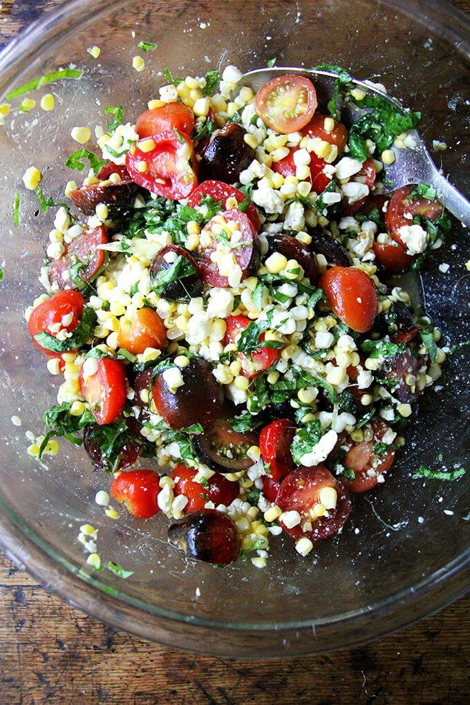 A bowl of corn and tomato salad.