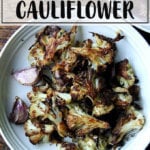 Oven-roasted cauliflower florets on a white plate.