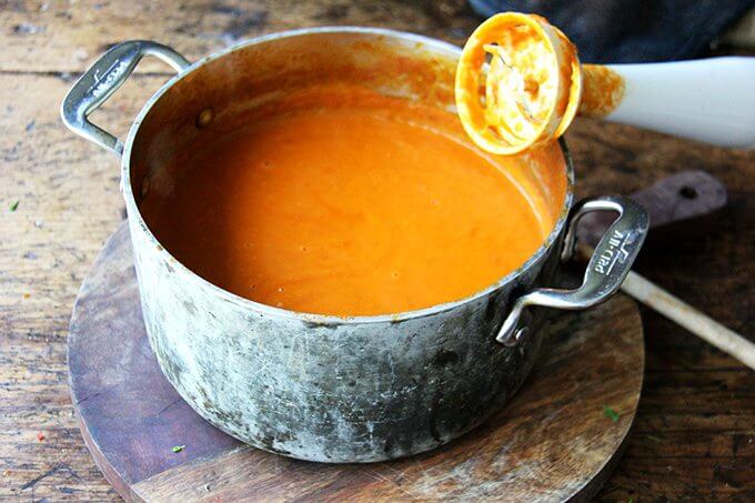 As delicious and simple as this tomato sauce is, I find the peeling step often deters me from making it. So I've stopped peeling the tomatoes and click here to find out what I do instead. Once you're finished making it, taste your fresh, bright tomato sauce, then smile for days as you put it on everything. // alexandracooks.com A pot of puréed tomato sauce aside an immersion blender.