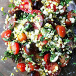 raw corn salad with tomatoes, basil, feta and lime