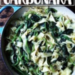 Skillet holding no-bacon carbonara loaded with greens.