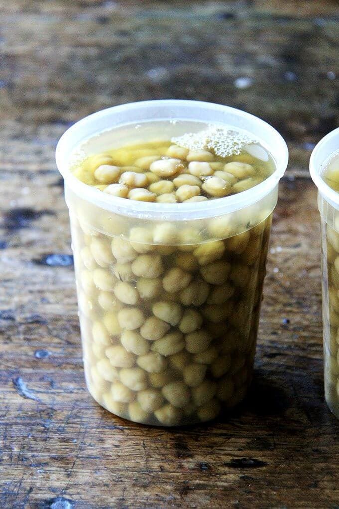 A quart container filled with cooked chickpeas.