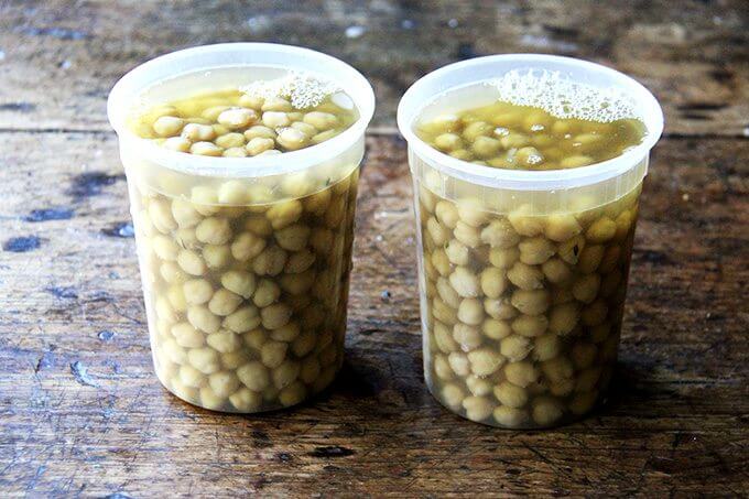 Two quart containers filled with cooked chickpeas.