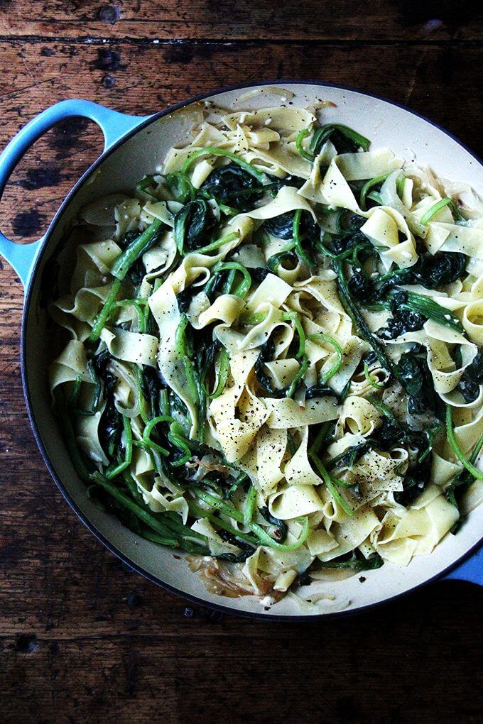 I love the addition of bacon found in classic carbonara recipes but it's not missed in this no-bacon pasta carbonara. And though the heap of greens wilts down to seemingly nothing, I know it's there, doing all the good things a heap of greens ought to be doing. // alexandracooks.com An overhead shot of a skillet filled with no-bacon carbonara.