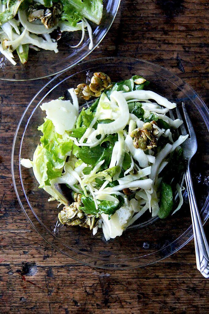 I don't think a fall salad needs to be anything more than greens plus a light dressing, but if you're up for taking it a step further, this is an irresistible option. // alexandracooks.com Two plates of a fall salad with cabbage, fennel, greens, and candied pepitas.