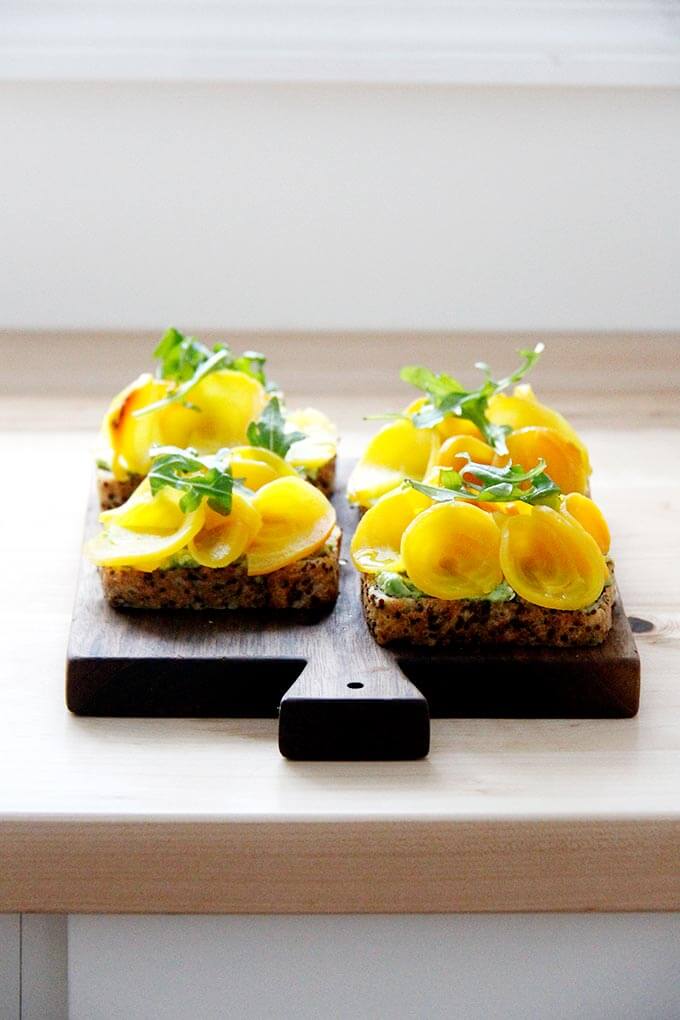 A board with beet tartines on the counter.