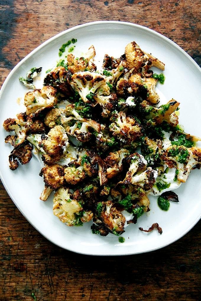 A plate of roasted cauliflower with schug.