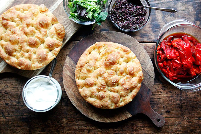 An overhead shot of a slab of focaccia on a board.