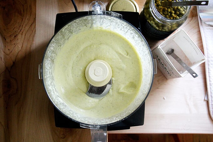 A food processor filled with homemade aioli.