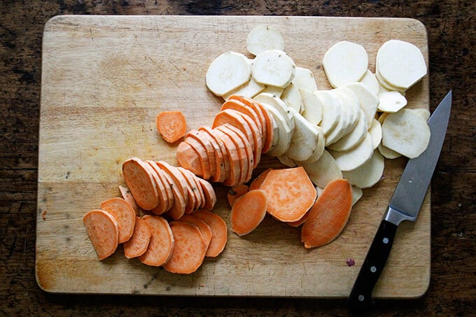 Sliced sweet potatoes on a board.