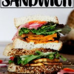 A sweet potato and pickled vegetable sandwich on a plate.