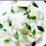A platter of kohlrabi salad with basil and parmesan.