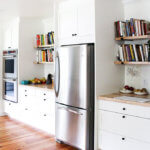 A recently remodeled kitchen with open shelves.