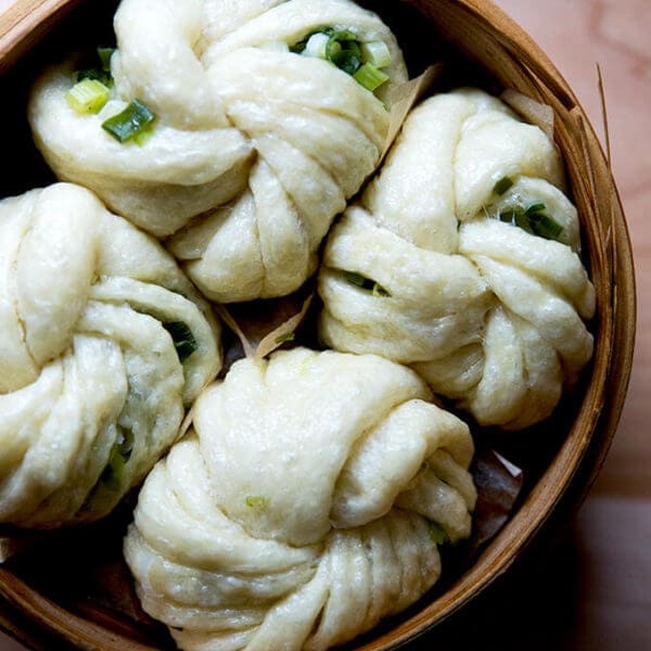 A steamer filled with Chinese steamed scallion buns.