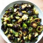 Balsamic Roasted Brussels sprouts with Manchego and almonds in a bowl.