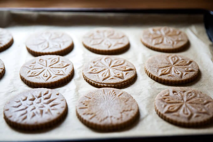 Stamped spiced brown butter muscovado cookies unbaked on cookie sheet.
