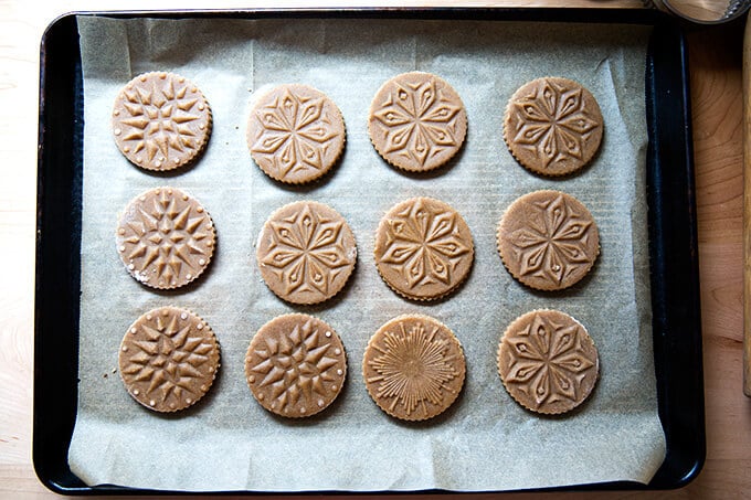 Just baked Stamped spiced brown butter muscovado cookies unbaked on sheet pan.