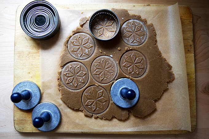 Rolled out cookie dough stamped with starry night cookie set.