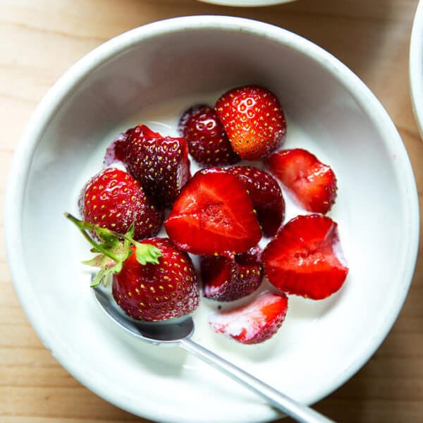 A bowl of strawberries and cream.