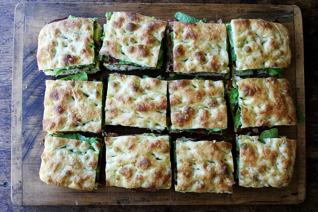 A cutting board with Ultimate Sheet Pan Breakfast Slab Sandwich