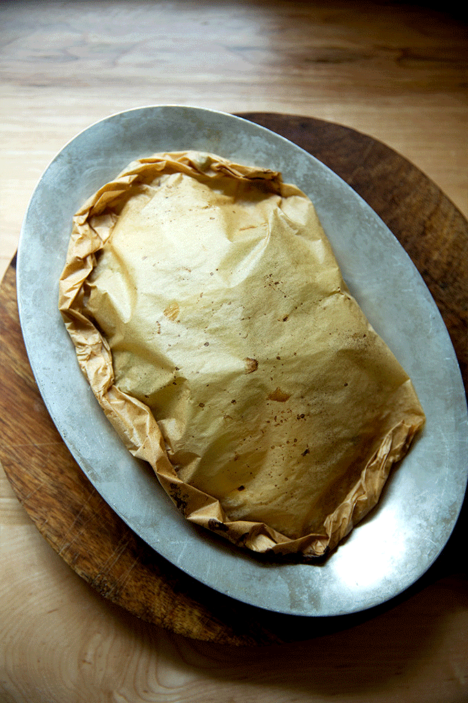 A sizzle pan of fish en papillote, just out of the oven.