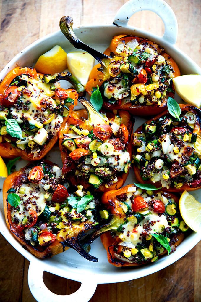 Roasted bell peppers stuffed with quinoa and sautéed corn, zucchini, and tomatoes.