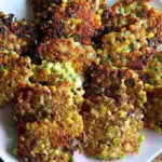 Corn fritters with cheddar and scallions on a platter.