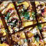 Nectarine, balsamic, and basil pizza cut into pieces.