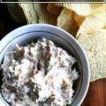 A bowl of real sour cream and onion dip aside Ruffles chips.