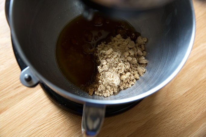 A stand mixer with clarified butter and brown sugar.