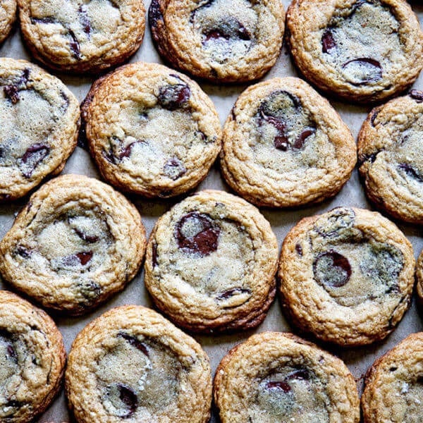 Gluten-free chocolate chip cookies on a sheet pan.