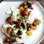 Seared cod with tomatoes, capers, and parsley.