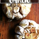 An overhead shot of two heads of whole roasted garlic.