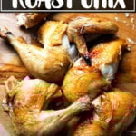 A board with a carved, perfectly roasted chicken.