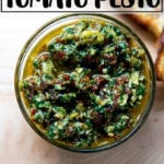 An overhead shot of a bowl holding sun dried-tomato pesto.