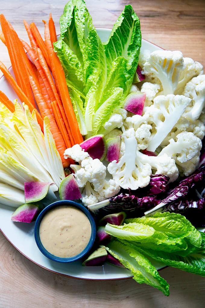 A platter of cruditรฉs with spicy cashew dip.