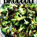 Spicy broiled broccoli with sesame-scallion oil on a plate.