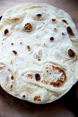 An overhead shot of a stack of homemade flour tortillas.