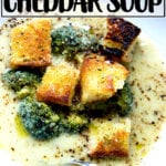 A bowl of broccoli-cheddar soup with olive oil toasted croutons.