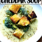A bowl of broccoli-cheddar soup with olive oil toasted croutons.