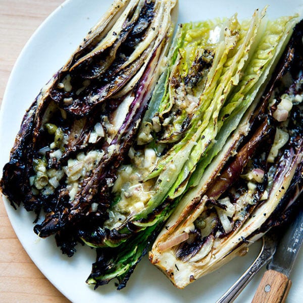 A plate of "grilled" Romaine salad with anchovy dressing.