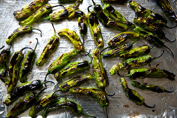 A sheetpan of broiled shishito peppers.