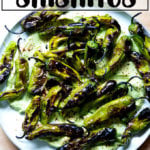 blistered shishitos with avocado crema on a platter.