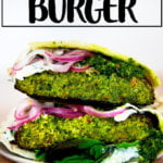 Halved falafel burger on a plate.