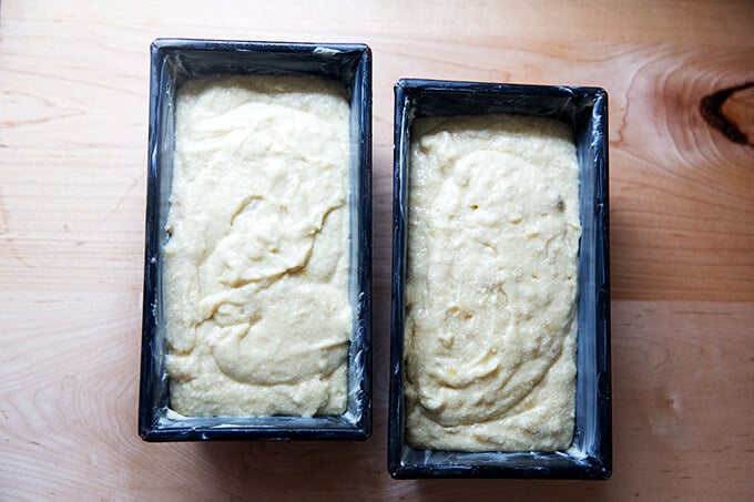 Two loaf pans with banana bread batter inside.