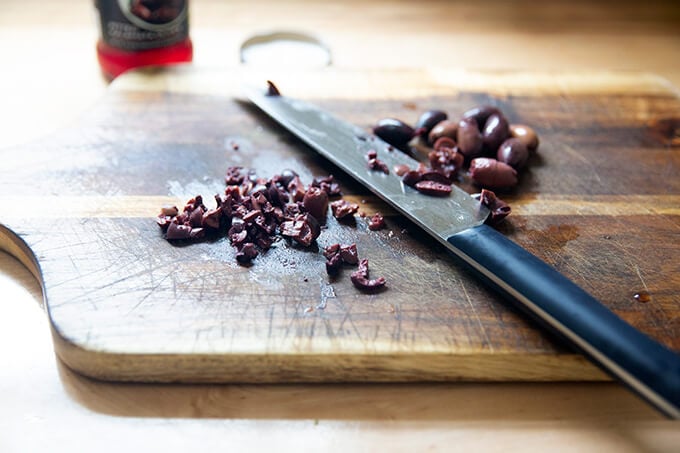 Chopped olives on a board.